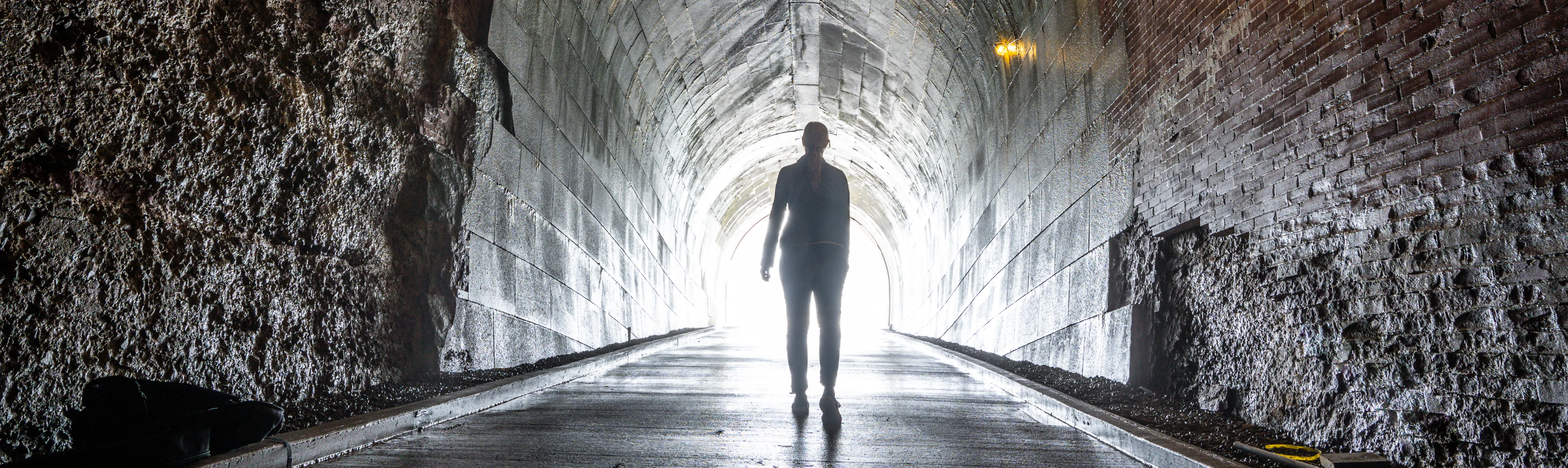 A person walking in a tunnel